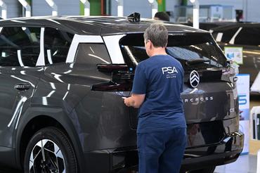 An employee wolks on the new Citroen C5 Aircross' production line in the Stellantis car maker plant in Chartres-de-Bretagne, near Rennes, western France, on July 3, 2025. (Photo by Damien MEYER / AFP)