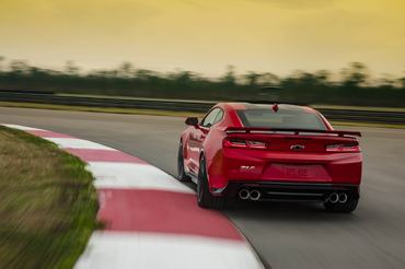 Rear view of 2023 Chevrolet Camaro ZL1 cornering on a track