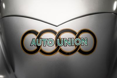 Audi recreated the Auto Union Lucca. After just over three years of construction, the record-breaking car was completed in early 2026. 
Detail: the Auto Union logo as used on the Auto Union racing cars of the 1930s.