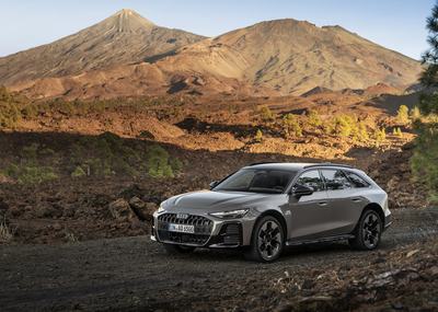 Audi A6 allroad (pearl grey) in a volcanic landscape with a striking mountain panorama.