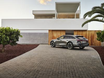 Audi A6 allroad (pearl grey) rear view in front of modern architecture (static shot)
