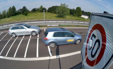 Cars drive past the so-called 'Optische Bremse' (optical brake) in Dessau-Rosslau, Germany, 11 August 2015. The term refers to prominent horizontal road markings kept in close proximity to each other to encourage car drivers to slow down. Photo: Hendrik Schmidt/dpa | usage worldwide   (Photo by Hendrik Schmidt/picture alliance via Getty Images)