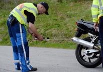 A policeman checks the noise level coming from a motorcycle exhaust on the Feldberg in the Black Forest, Germany, 18 May 2014. After a marked increase in deadly motorcycle accidents, the police in Freiburg have increased controls on motorcycles. Photo: Patrick Seeger/dpa | usage worldwide   (Photo by Patrick Seeger/picture alliance via Getty Images)