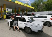 A driver pushes his car to a petrol station trying to buy fuel in Odesa, Ukraine 18 May 2022. Private public transport companies of Odesa have reduced the number of exits of their buses on routes due to lack of gasoline, according to local media. The operational headquarters under the Cabinet of Ministers decided to abandon state regulation of fuel prices, media reported on 17 May, referring to the Minister of Economy.  Long queues have formed for petrol stations in Ukraine, as the country have fuel shortages, amid Russian invasion in Ukraine. (Photo by STR/NurPhoto via Getty Images)