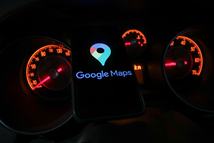 Google Maps logo displayed on a phone screen and car gauges are seen in this illustration photo taken in Krakow, Poland on January 13, 2023. (Photo by Jakub Porzycki/NurPhoto via Getty Images)