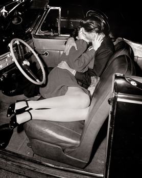 1940s Close-Up Of Passionate Hugging  Kissing Couple Man Woman Lying In Front Seat Of Convertible Car At Outdoor Drive-In Movie   (Photo by American Stock/Getty Images)
