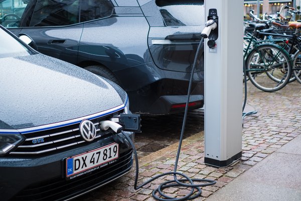 Copenhagen, Denmark - April 6, 2024: Electric vehicle parked on a street and charging.