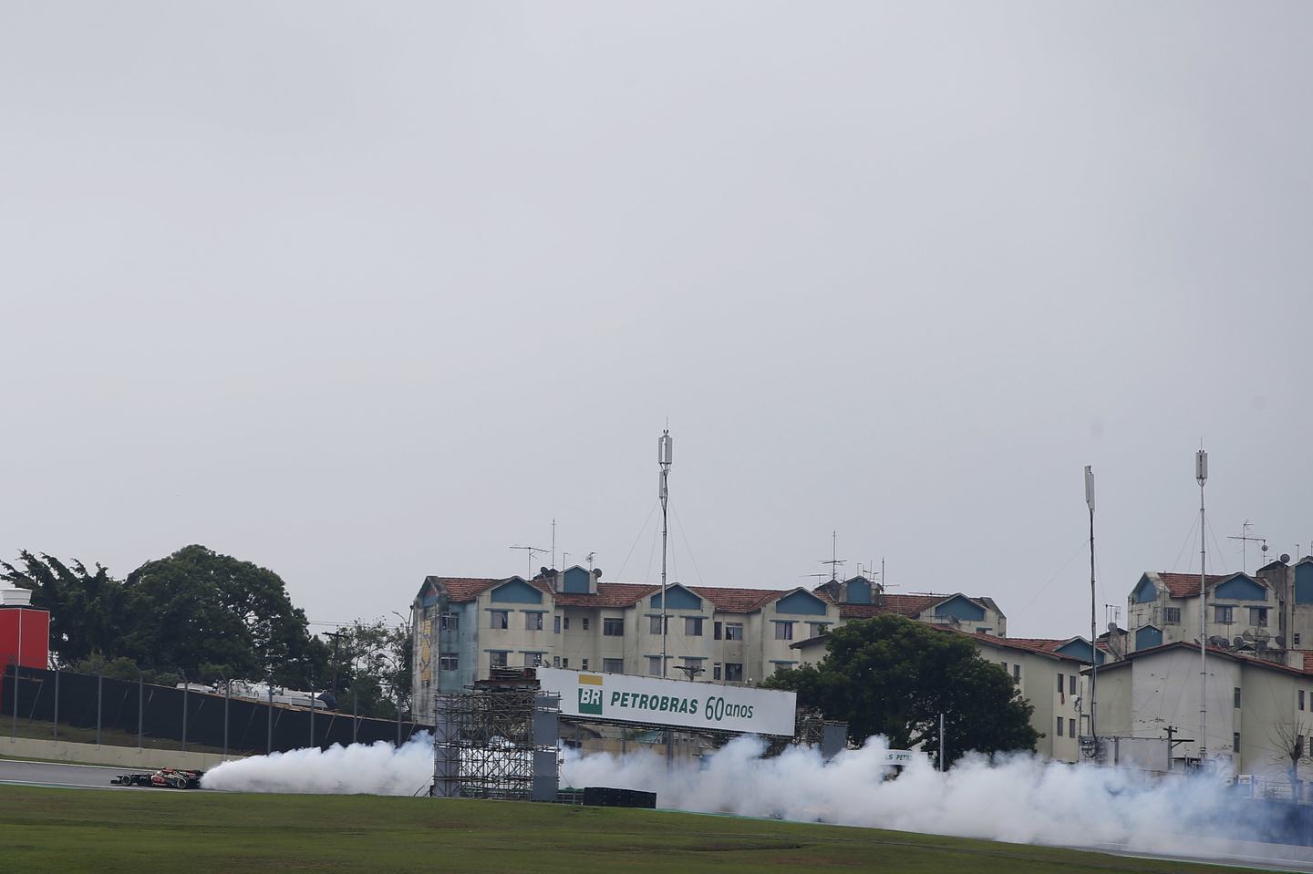 Interlagos, Sao Paulo, Brazil. Sunday 24th November 2013. Romain Grosjean, Lotus E21 Renault, coasts to a stop as his engine erupts in a pall of smoke. (Photo by Glenn Dunbar/LAT Images)