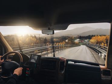 Point of view mobile phone picture of a man driving a bus in Norway