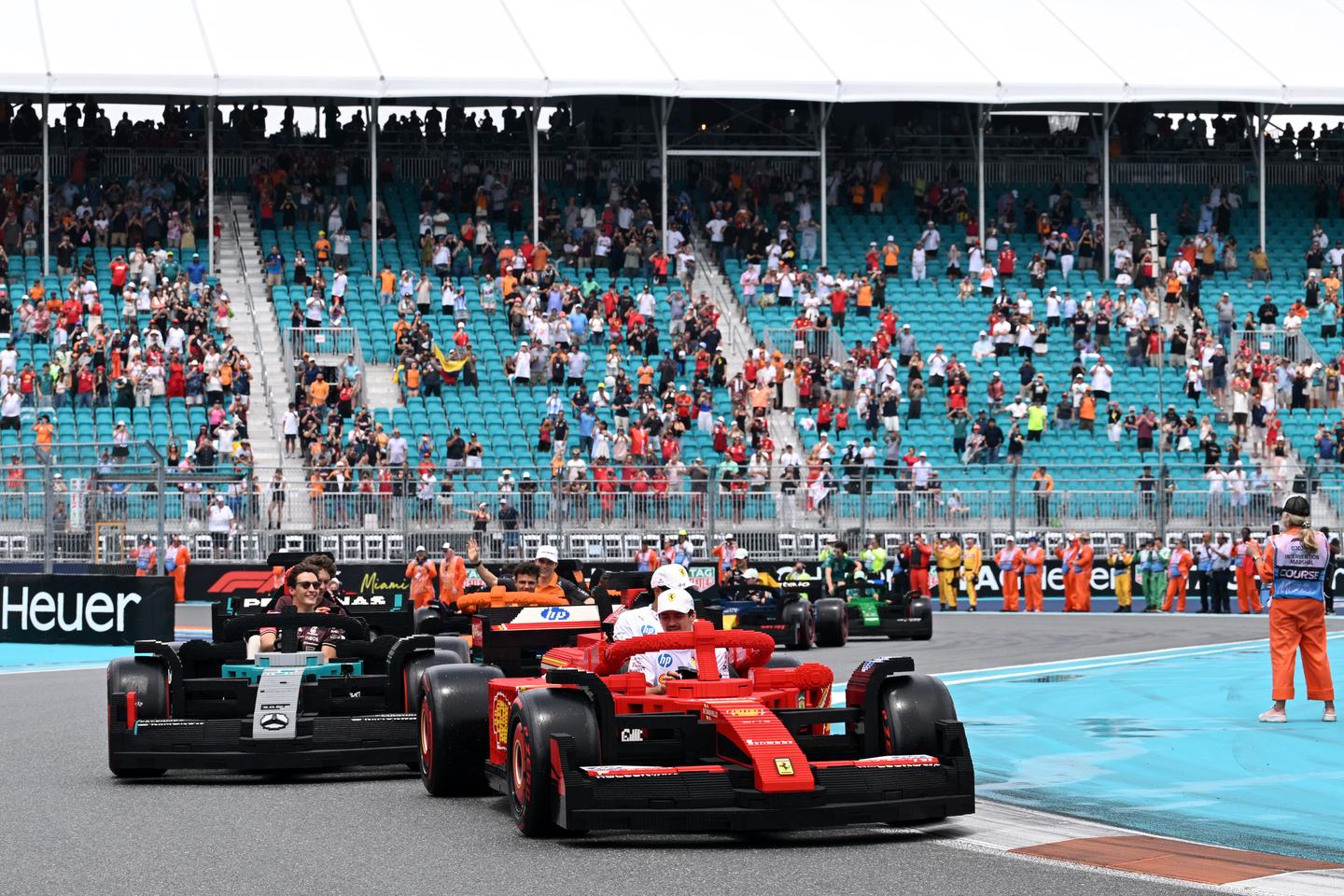 MIAMI, FLORIDA - MAY 04: Charles Leclerc of Monaco and Scuderia Ferrari Lewis Hamilton of Great Britain and Scuderia Ferrari George Russell of Great Britain and Mercedes AMG Petronas F1 Team and Andrea Kimi Antonelli of Italy and Mercedes AMG Petronas F1 Team lead the Lego drivers parade prior to the F1 Grand Prix of Miami at Miami International Autodrome on May 04, 2025 in Miami, Florida. (Photo by Mark Sutton - Formula 1/Formula 1 via Getty Images)