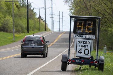 Vadnais Heights, Minnesota. A vehicle passes a radar trailer that helps enforce speed limits.. (Photo by: Michael Siluk/UCG/Universal Images Group via Getty Images)