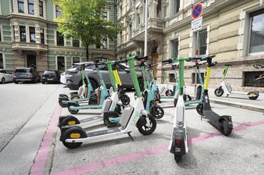 Innsbruck, Austria. July 31, 2025. some electric scooters for rent on a sidewalk in the city center