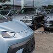 Crewe, Cheshire, England, August 30th 2025. A pale blue BYD Dolphin is parked at the dealership forecourt, with cars in the background.