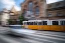 Yellow City Tram Rushes In Motion On A Blurred Budapest Street