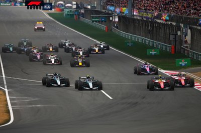 SHANGHAI, CHINA - MARCH 15: Lewis Hamilton of Great Britain driving the (44) Scuderia Ferrari SF-26 and Andrea Kimi Antonelli of Italy driving the (12) Mercedes AMG Petronas F1 Team W17 battle for track position into turn one at the start during the F1 Grand Prix of China at Shanghai International Circuit on March 15, 2026 in Shanghai, China. (Photo by Sona Maleterova/Getty Images)