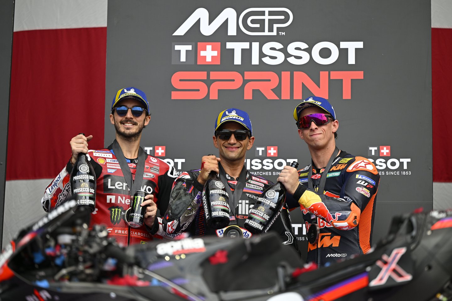 AUSTIN, TEXAS - MARCH 28: Francesco Bagnaia of Italy riding the Lenovo Ducati (63), Jorge Martin of Spain riding the Aprilia Racing bike (89) and Pedro Acosta of Spain riding the Red Bull KTM Factory Racing bike (37) on the podium during the Sprint ahead of the MotoGP of United States at Circuit of The Americas on March 28, 2026 in Austin, Texas. (Photo by Gold & Goose Photography/Getty Images)