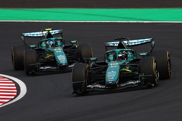 SUZUKA, JAPAN - MARCH 29: Lance Stroll of Canada driving the (18) Aston Martin F1 Team AMR26 Honda leads Fernando Alonso of Spain driving the (14) Aston Martin F1 Team AMR26 Honda on track during the F1 Grand Prix of Japan at Suzuka Circuit on March 29, 2026 in Suzuka, Japan. (Photo by Clive Rose - Formula 1/Formula 1 via Getty Images)