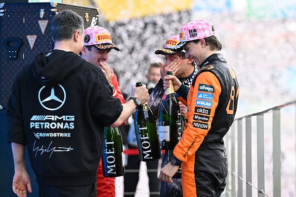 SUZUKA, JAPAN - MARCH 29: Race winner Andrea Kimi Antonelli of Italy and Mercedes AMG Petronas F1 Team Second placed Oscar Piastri of Australia and McLaren Third placed Charles Leclerc of Monaco and Scuderia Ferrari and Giacomo Tortora, Director of Car Design at Mercedes AMG Petronas F1 Team celebrate on the podium during the F1 Grand Prix of Japan at Suzuka Circuit on March 29, 2026 in Suzuka, Japan. (Photo by Mark Sutton - Formula 1/Formula 1 via Getty Images)