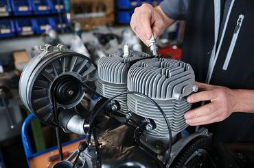 27 April 2026, Saxony, Zwickau: Frank Hofmann, head of Trabantwelt Zwickau, screws a spark plug into the cylinder head of a two-stroke engine for a Trabant 601 in the spare parts dealer's workshop. The company has been one of the larger suppliers of Trabi spare parts for 23 years. Some of these still come from original stocks, but the production of new parts plays a greater role, says the managing director. Tens of thousands of vintage GDR cars such as the Trabant, whose production ended on April 30, 1991, are still on the road, and registration figures have recently risen again. Photo: Jan Woitas/dpa (Photo by Jan Woitas/picture alliance via Getty Images)