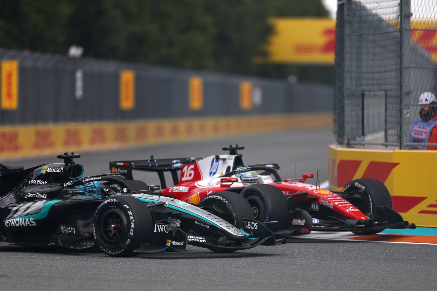 MIAMI, FLORIDA - MAY 03: George Russell of Great Britain driving the (63) Mercedes AMG Petronas F1 Team W17 and Charles Leclerc of Monaco driving the (16) Scuderia Ferrari SF-26 battle for track position during the F1 Grand Prix of Miami at Miami International Autodrome on May 03, 2026 in Miami, Florida. (Photo by Andy Hone/LAT Images)