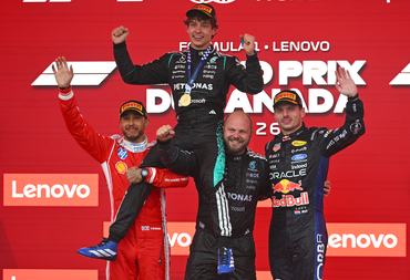 MONTREAL, QUEBEC - MAY 24: Race winner Andrea Kimi Antonelli of Italy and Mercedes AMG Petronas F1 Team Second placed Lewis Hamilton of Great Britain and Scuderia Ferrari Third placed Max Verstappen of the Netherlands and Oracle Red Bull Racing and Dean Hale, Senior Race Team Composite Technician at Mercedes AMG Petronas F1 Team on the podium during the F1 Grand Prix of Canada at Circuit Gilles-Villeneuve on May 24, 2026 in Montreal, Quebec. (Photo by Rudy Carezzevoli/Getty Images)