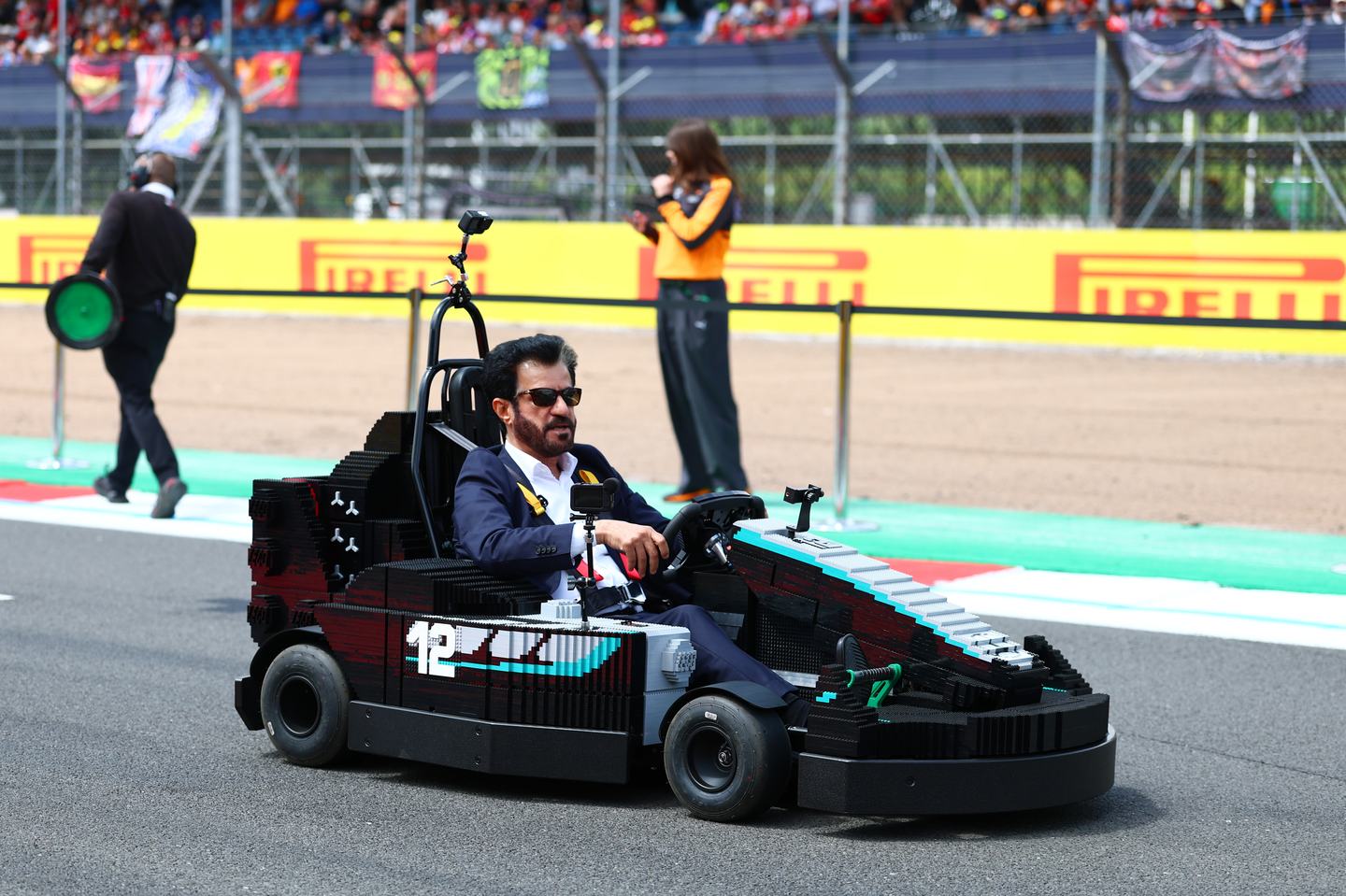 NORTHAMPTON, ENGLAND - JULY 05: Mohammed ben Sulayem, FIA President drives a Lego Minicar on the drivers parade prior to the F1 Grand Prix of Great Britain at Silverstone Circuit on July 05, 2026 in Northampton, England. (Photo by Bryn Lennon - Formula 1/Formula 1 via Getty Images)