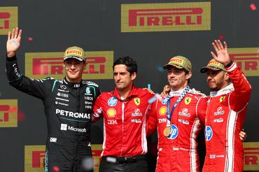 NORTHAMPTON, ENGLAND - JULY 05: Race winner Charles Leclerc of Monaco and Scuderia Ferrari Second placed George Russell of Great Britain and Mercedes AMG Petronas F1 Team Third placed Lewis Hamilton of Great Britain and Scuderia Ferrari and Bryan Bozzi, Race Engineer of Scuderia Ferrari on the podium during the F1 Grand Prix of Great Britain at Silverstone Circuit on July 05, 2026 in Northampton, England. (Photo by Clive Mason/Getty Images)
