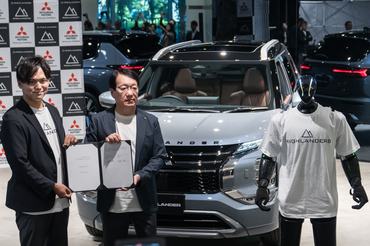 TOKYO, JAPAN - JULY 09: Highlanders Inc. CEO Hiroya Masuoka (L) and Mitsubishi Motors Corp. Chairman and CEO Takao Kato (R) hold a signed Memorandum of Understanding (MOU) as they pose with a humanoid robot named N, manufactured by Highlanders, at its unveiling at the Mitsubishi Motors headquarters on July 09, 2026, in Tokyo, Japan. Mitsubishi Motors and Highlanders unveiled a prototype of a humanoid robot capable of transporting automobile parts and assembling engines on a production line. The robot is scheduled to enter mass production in Japan in 2027. (Photo by Tomohiro Ohsumi/Getty Images)