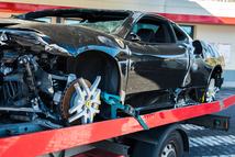 Imperia, Italy - March 15, 2013: Black Ferrari loaded on wrecker after accident to be taking away for repair.