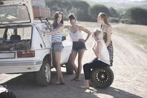 Friends on a road trip changing the car's tyre