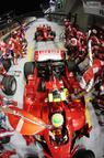 SINGAPORE - SEPTEMBER 28:  Felipe Massa of Brazil and Ferrari drives off with his refuelling hose still attached while Kimi Raikkonen of Finland and Ferrari waits behind to come in for his pitstop during the Singapore Formula One Grand Prix at the Marina Bay Street Circuit on September 28, 2008 in Singapore.  The event is the first Formula One race to be held at night.  (Photo by Mark Thompson/Getty Images)