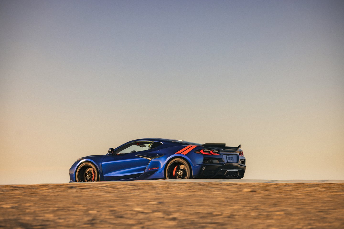 A rear 3/4 view of the 2027 Chevrolet Corvette Grand Sport in Admiral Blue Metallic.