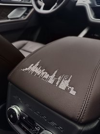 The city skyline is stitched into the center console.
