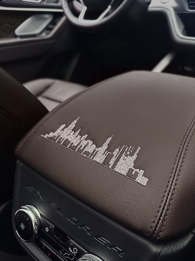 The city skyline is stitched into the center console.