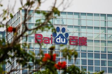 SHENZHEN, CHINA - MARCH 21: The logo of Baidu is seen on an office building behind kapok flowers on March 21, 2026 in Shenzhen, China. The company continues to invest in artificial intelligence and autonomous technologies as competition intensifies in Chinaâs rapidly evolving AI sector. (Photo by Cheng Xin/Getty Images)